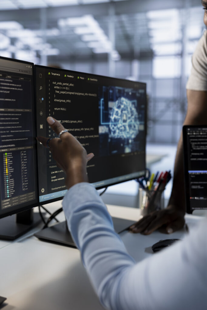 Computer scientists using machine learning applications to optimize server farm operations. Close up of IT professionals using PC to implement server virtualization in data center